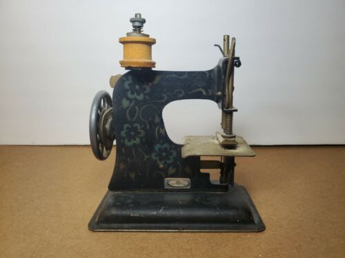 German toy sewing machine with a floral design